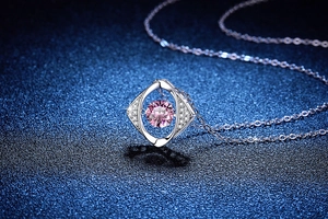 Macro detail of 925 sterling silver rhombus necklace with dancing pink gemstone
