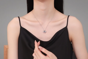 Detailed close-up of 925 sterling silver geometric pendant necklace on model's neck