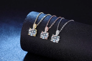 Macro shot of 1 carat round moissanite necklaces in gold, rose gold and silver finishes