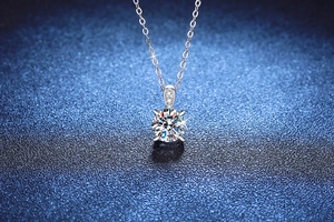 Close-up of s925 silver necklace featuring a 1ct moissanite pendant with four-claw setting