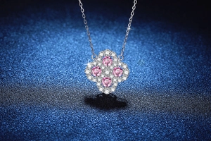 Detailed macro of S925 silver four-leaf clover pendant with pink moissanite and micro diamonds