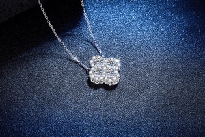 Macro view of a 925 silver four-leaf clover pendant with sparkling moissanite stones