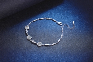 Detail of 925 silver bracelet featuring plum blossom motifs and sparkling moissanite