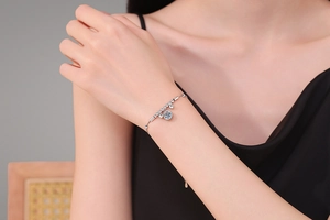 Detail of a 1-carat moissanite bracelet on wrist with elegant silver bead chain links