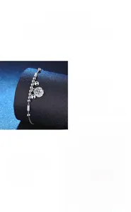 Close-up of S925 silver bracelet featuring round moissanite inlay and lobster clasp detail