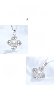 Macro shot of silver clover pendant with white pearl and sparkling moissanite accents
