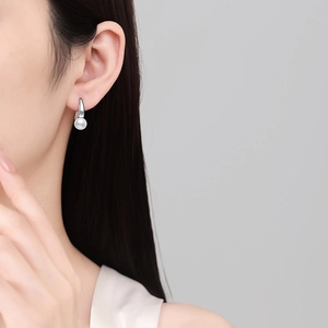 Elegant S925 sterling silver drop earrings with natural freshwater pearls on female model