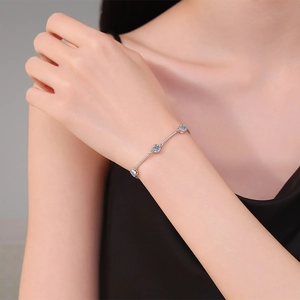 S925 sterling silver bracelet with blue moissanite stones on a woman's wrist