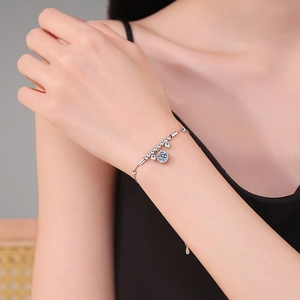 925 Sterling silver bracelet with 1 carat moissanite charm worn on woman's wrist