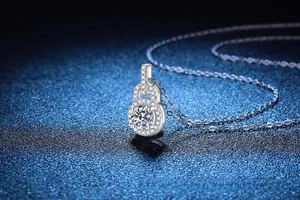 Macro shot of 1 carat moissanite pendant with micro-paved diamonds on a 925 silver chain