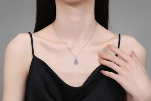 Close-up of S925 sterling silver padlock necklace with a blue moissanite pendant on model