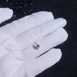 Detail of s925 silver moissanite teardrop pendant on an invisible thin fish line