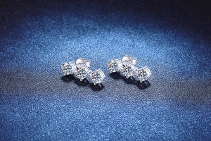 Macro shot of 925 silver stud earrings with 3-carat moissanite stones on blue background