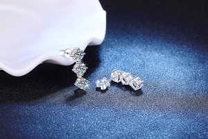 Macro shot of 925 sterling silver tassel earrings with three sparkling moissanite stones