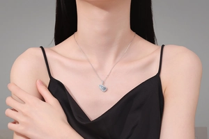 Macro shot of 925 sterling silver necklace with double pear-shaped moissanite pendants