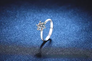 Macro shot of 1 carat round cut moissanite ring with elegant six-prong lotus setting