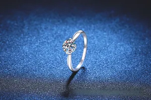 Detail of a 1 carat round moissanite ring with classic four-prong setting in silver