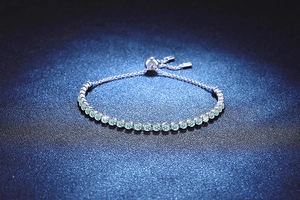 Detailed macro of S925 silver bolero bracelet with light blue round cut stones