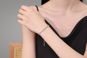 Elegant S925 silver bracelet with light blue moissanite crystals on a woman's wrist