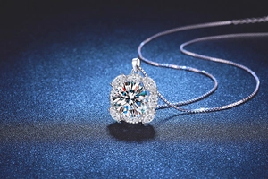 Macro shot of 10-carat halo moissanite pendant with marquise side stones on silver box chain