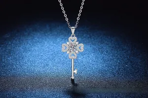 Close-up of S925 silver clover key pendant necklace with moissanite and pave stones
