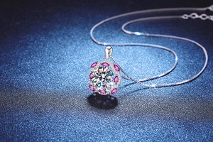 Macro shot of 10-carat round brilliant-cut stone and pink marquise gems on S925 silver pendant