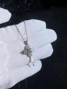 Close-up of S925 silver four-leaf clover key necklace pendant set with moissanite