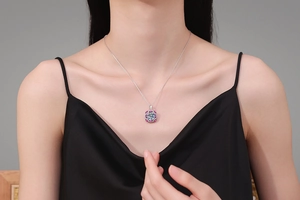 Macro detail of 10ct moissanite necklace pendant with pink halo on silver chain