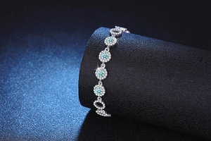 Détail du bracelet en argent s925 avec pierres moissanites bleues et sertissage halo