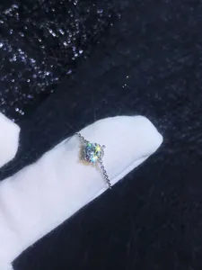 Detail of s925 silver mermaid ring with sparkling moissanite in a four-prong chain setting