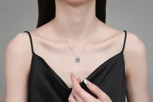 Detail of elegant S925 silver horseshoe necklace with 2ct moissanite worn by a model