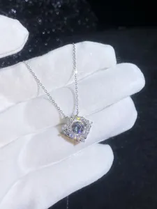 Macro shot of S925 sterling silver halo necklace featuring a brilliant 1ct moissanite pendant