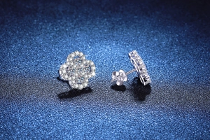 Macro shot of S925 sterling silver four-leaf clover earrings with sparkling pavé stones