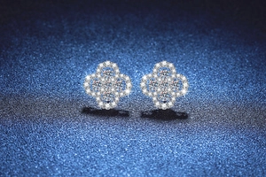 Macro shot of S925 sterling silver four-leaf clover stud earrings with pavé set crystals