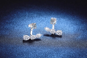 Macro detail of S925 sterling silver ear jackets with moissanite pear cut stones