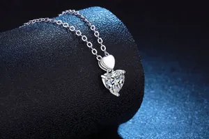 Detail showing the heart-shaped moissanite pendant and silver claw setting