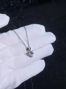 Macro shot of 925 silver heart necklace featuring a sparkling 1-carat moissanite pendant