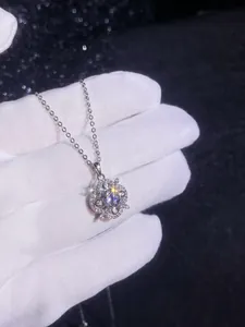 Macro shot of 925 sterling silver four-leaf clover pendant with sparkling moissanite stone