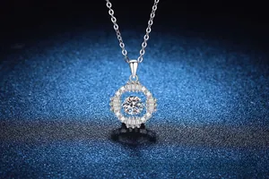 Macro detail of 925 silver moissanite halo pendant with round and baguette cut diamonds