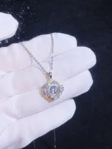 Macro shot of silver 1ct moissanite pendant featuring radiant baguette and round diamonds