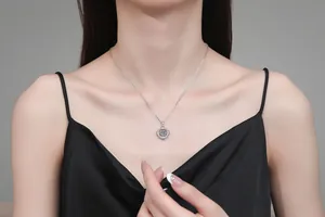 On-model view of a 925 sterling silver necklace featuring a 1ct moissanite dancing pendant