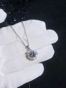 Macro view of a 925 sterling silver moissanite necklace with brilliant cluster pendant