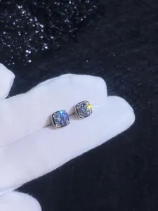 Macro view of princess cut moissanite stud earrings in a four-prong S925 silver setting