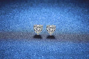 Detail showing heart-cut moissanite stones with secure three-prong silver claw setting