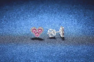 Macro view of S925 sterling silver heart earrings with three pink zirconia stones