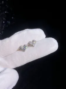 Macro shot of S925 sterling silver heart stud earrings with cubic zirconia stones