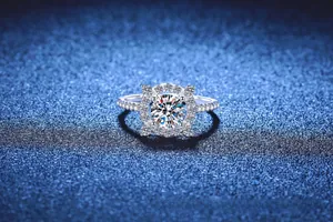 Macro shot of 1 carat moissanite ring with halo setting and pavé silver band