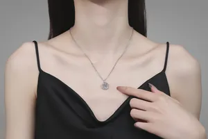 Close-up of a 925 sterling silver swan heart necklace with 1ct moissanite on a model