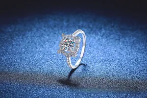 Macro shot of 1 carat moissanite silver ring with halo setting and pavé band details