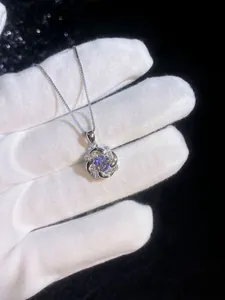 Close-up of S925 sterling silver rotating windmill pendant with sparkling moissanite stone